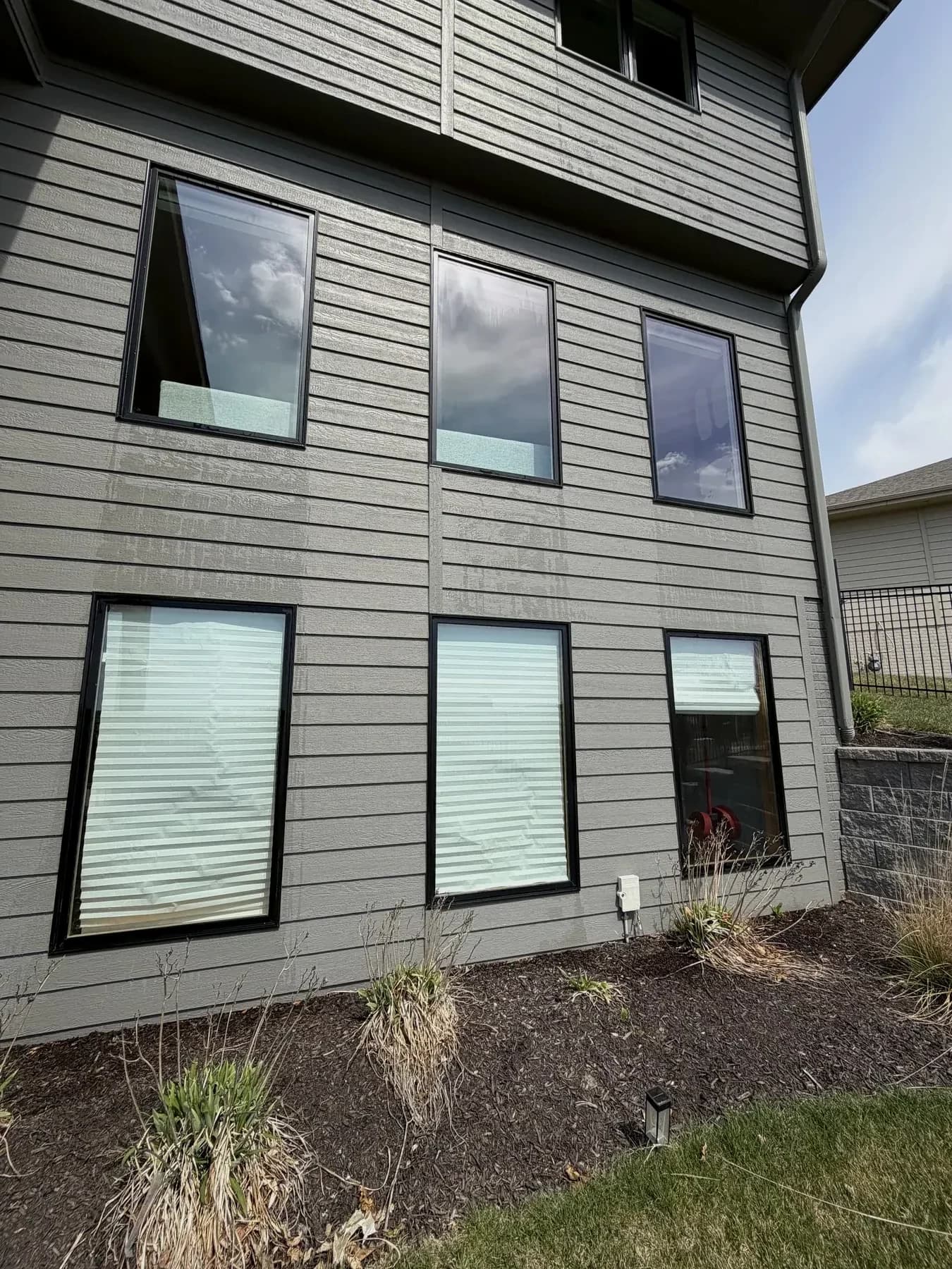 Residential window cleaning on a modern Omaha home