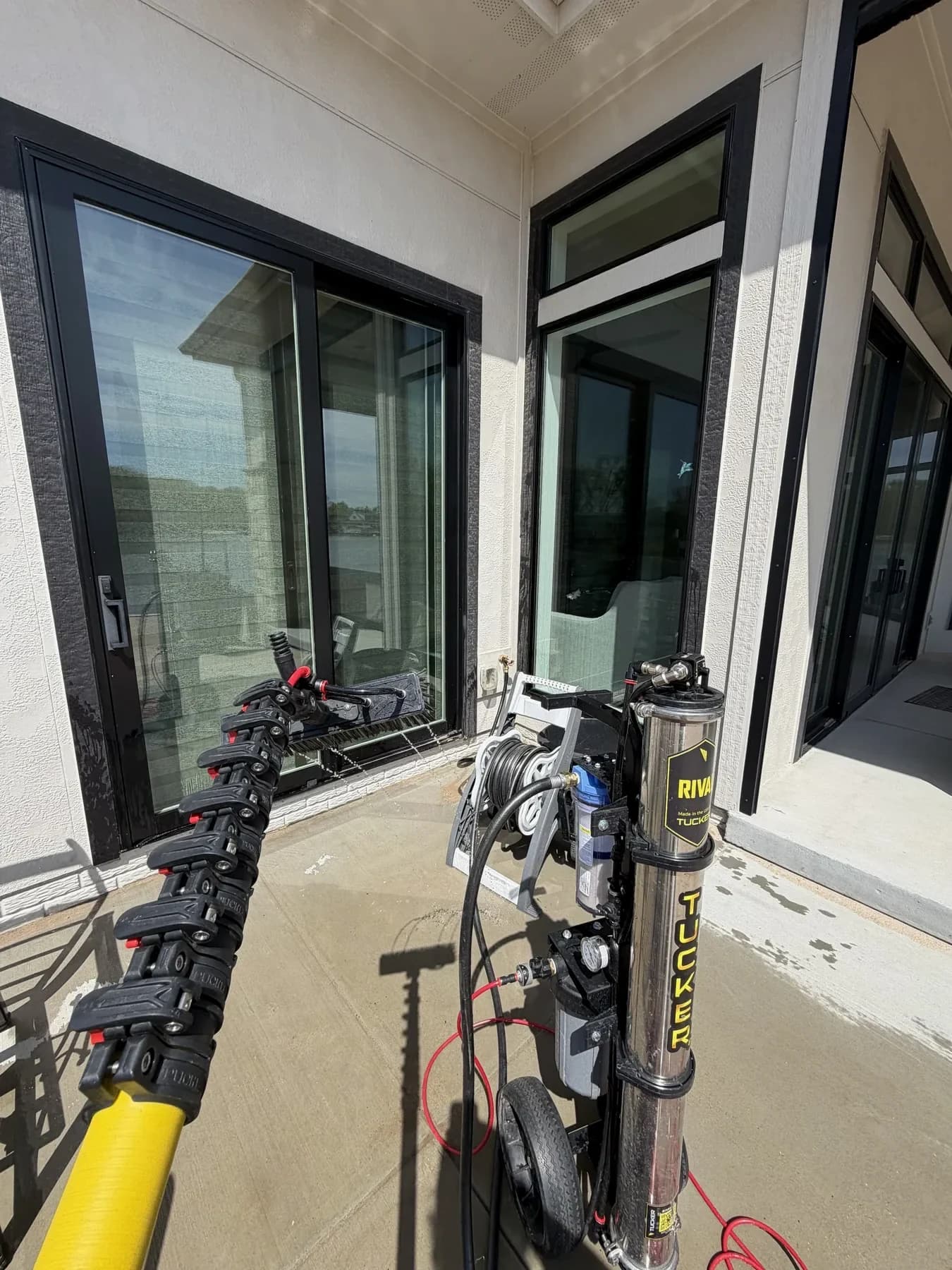 Water-fed pole brush cleaning a window in Omaha, NE