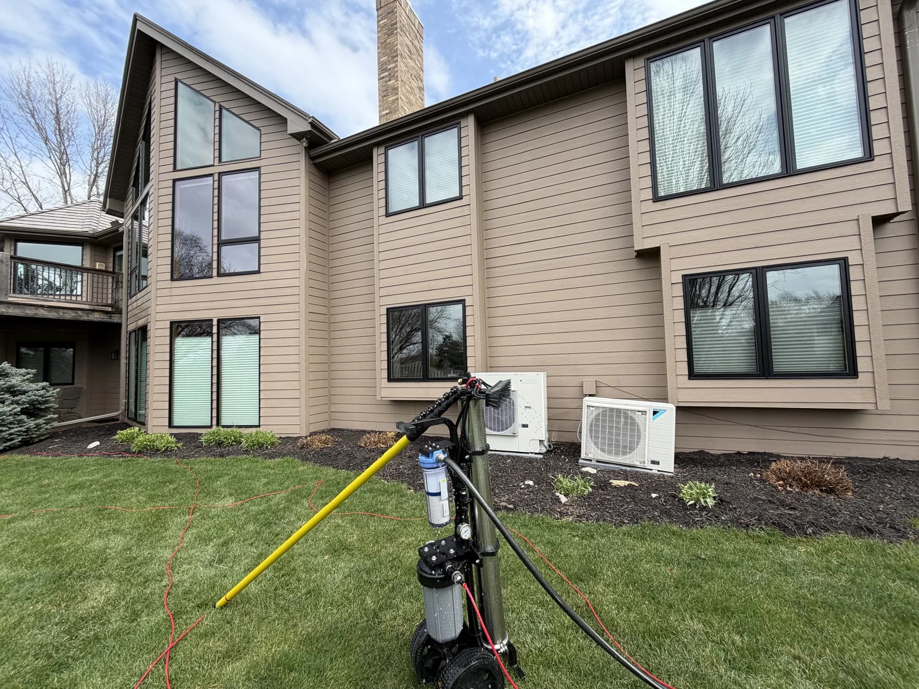 A water-fed pole rig set up on the lawn of an Omaha home