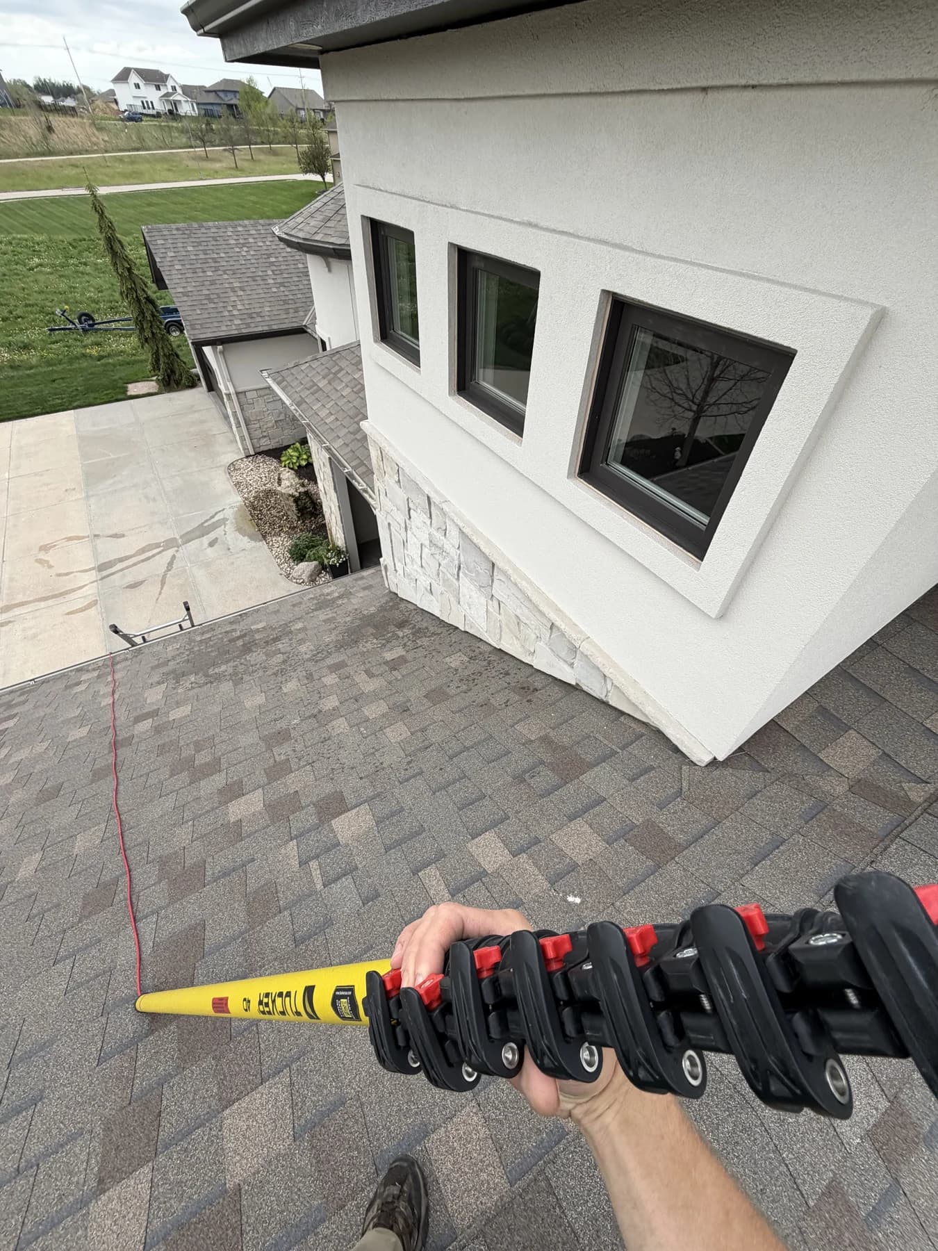 Reaching dormer glass from the roof with a water-fed pole