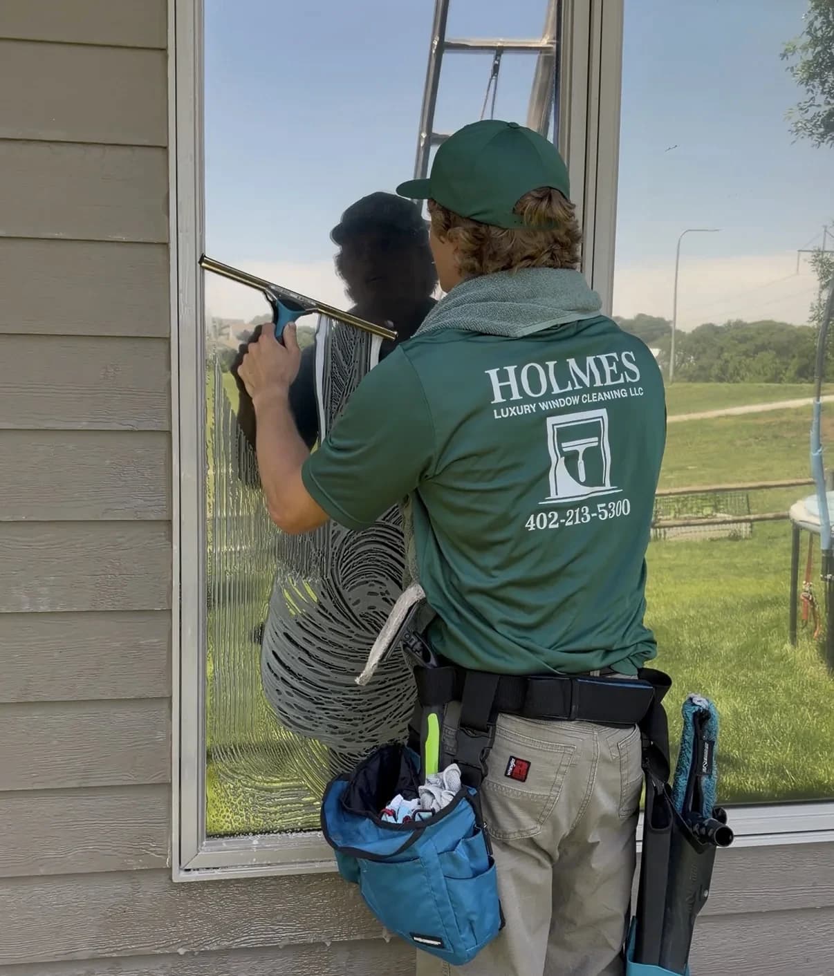 Hand-finishing a pane on an Omaha home